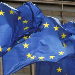 European Union flags aflutter outside EU Commission headquarters in Brussels, Belgium.