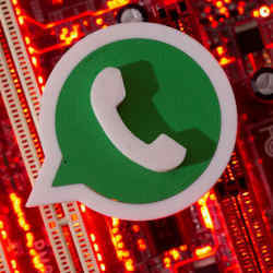 The WhatsApp logo over a motherboard.