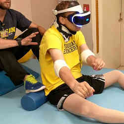 Michael Heinrich, who lost the use of the lower half of his body after an accident, undergoes virtual reality therapy.