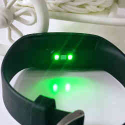 Green LEDs on the back of a smartphone wristband.