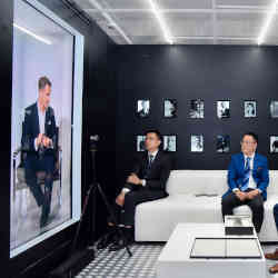 IWC chief executive Christoph Grainger-Herr (left) appears as a hologram during a trade show event using Portl technology.