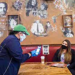 Employees of D.C. restaurant chain Busboys and Poets training on a new contactless-ordering system. 