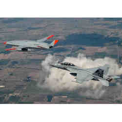 An MQ-25 drone refueling an F/A-18 aircraft. 