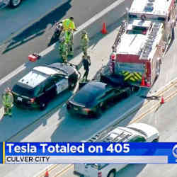 Television news coverage of the crash of a Tesla. 