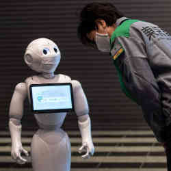 Tokyos governor Yuriko Koike meeting SoftBanks Pepper robot at an event last year.