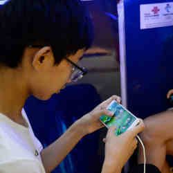 A boy playing a game by Tencent during an event at a mall in Handan, China.