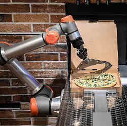 A robot prepares a pizza.