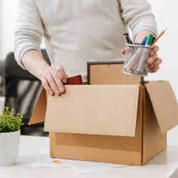 An IT worker packing his things after quitting.