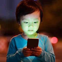 A smartphone scans a child's face.