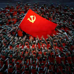 Performers rally around a flag bearing the symbol of Chinas communist party during a show in Beijing last month commemorating the 100th anniversary of its founding.