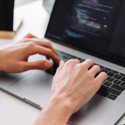 hands on laptop keyboard