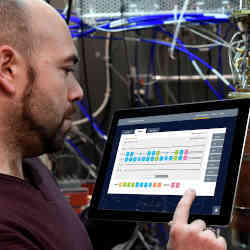 A researcher oversees the operation of a quantum computer. 