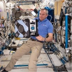 Flight Engineer David Saint-Jacques prepping the free-flying Astrobee robotic assistant for a mobility test.