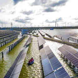 Electrical workers check solar panels at a photovoltaic power station in Haian, in China's eastern Jiangsu province. 