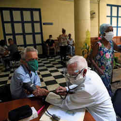 A doctor checks a mans blood pressure before inoculating him with the Cuban-made Abdala vaccine in Havana.