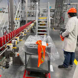 A person works with robots at Procter & Gambles Tabler Station factory in Martinsburg, WV.