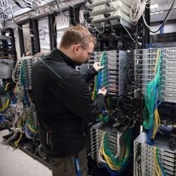 photo of man working at data center