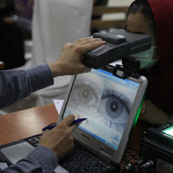 woman getting eye scan at passport office in Kabul, Afghanistan