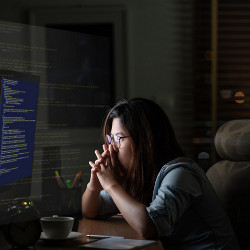 woman at computer screen at night