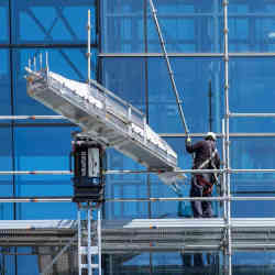 A construction work working with Kewazo's scaffolding robot.