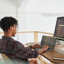 Software developer/coder working on laptop