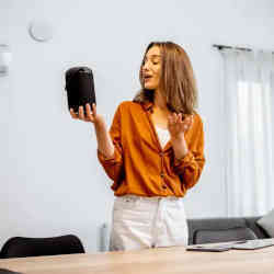 A woman using a smart home assistant.