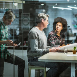 men and woman at workplace meeting