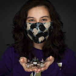 Melanie Anderson, a doctoral student in mechanical engineering at the University of Washington, holding the Smellicopter.