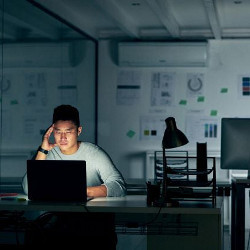 isolated worker in dark office