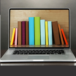 row of books on laptop computer display