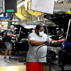 A Ford assembly line worker in Wayne, MI.