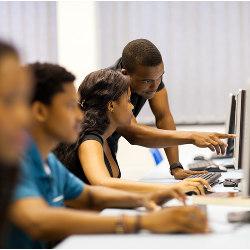 instructor points to a student's computer screen