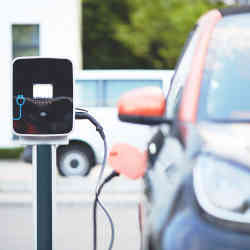 An electric vehicle plugged into a charging station. 