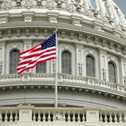 Close-up of the U.S. Capitol building with an American flag.