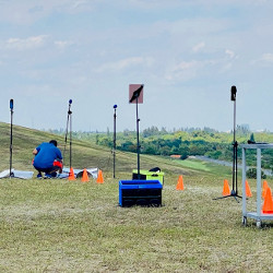 researcher and microphones recording sounds at an outdoor park