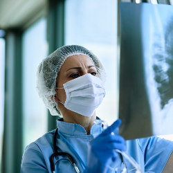 female radiologist examining an x-ray