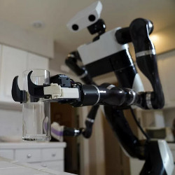 a Toyota Research Institute robot lifts a clear glass