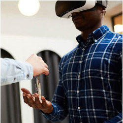 keys are handed to an applicant wearing a VR headset
