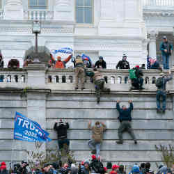 Supporters of President Donald Trump climb the west wall of the U.S. Capitol on Jan. 6, 2021.