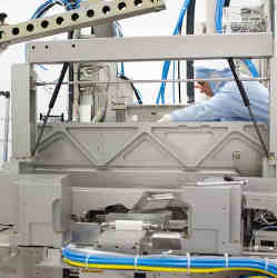 Workers install photolithography equipment in an ASML factory.