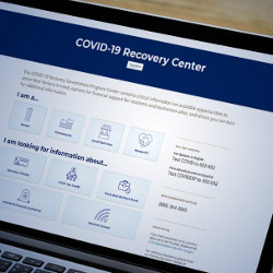 laptop displays the NYC COVID-19 Recovery Center website