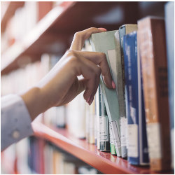 hand pulls book from library shelf