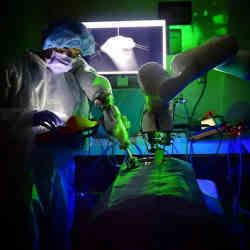 Researcher Hamed Saeidi watches the autonomous robot perform surgery.