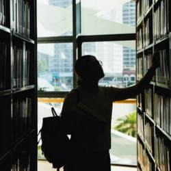 student browsing library shelves