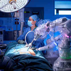 A Da Vinci surgical robot works with a human surgeon. 