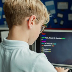 young coder at computer display