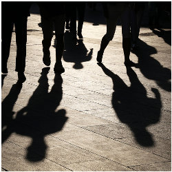 silhouettes and shadows of people on the street