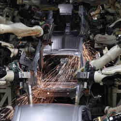 Robot arms weld the bodies of fourth-generation Toyota Prius cars on the production line at the company's Tsutsumi assembly plant in Toyota City, Aichi prefecture, Japan.