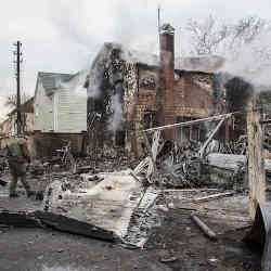 Ukrainian servicemen walk at fragments of a downed aircraft seen in in Kyiv, Ukraine.