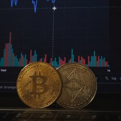 Two bitcoin and a financial chart.